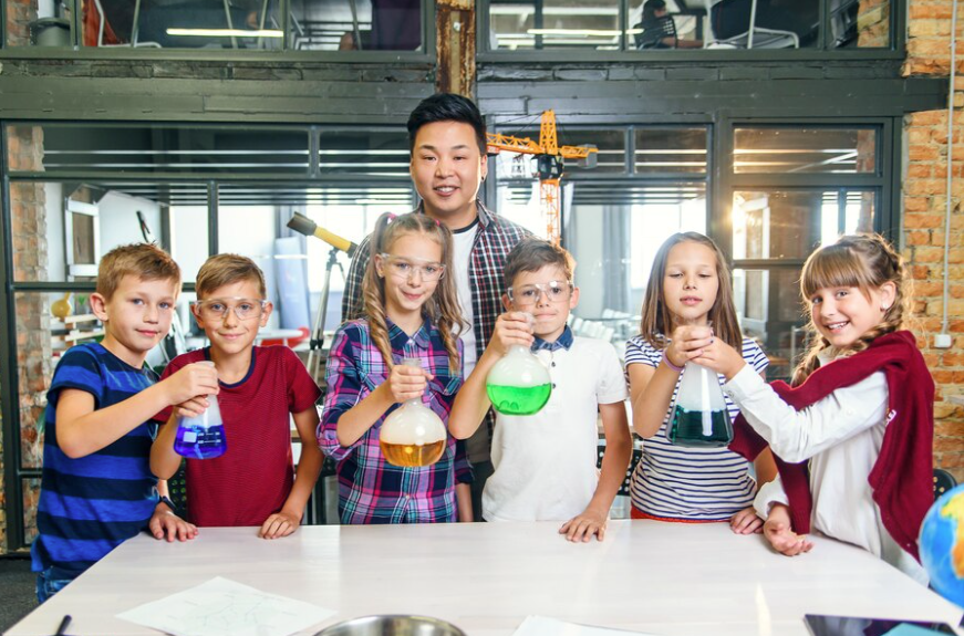 5 Major Factors Why a Singapore IB School Is the Best Option for Your Child? Premium Photo Photo Korean Teacher With Group Of Six Cheerful Young Caucasian Pupils Wearing Goggles During Chemical Experiment In Modern School Hold Test Glass With Colored Liquid